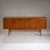 Spacious mid-century sideboard, likely of Italian origin, dating to the 1960s. The body is finished in warm-toned teak...