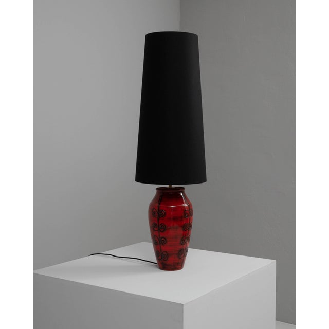 This eye-catching 20th-century German ceramic table lamp is a vibrant statement piece. The bold red base, with its glossy...