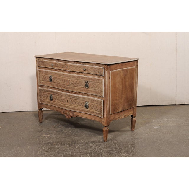 A fine Italian two-drawer serpentine carved-wood chest from the turn of the 18th and 19th centuries. This antique chest...