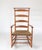 Antique Shaker style maple wood ladder back rocking chair. Features shawl bar, checkered woven seat and distinctive...