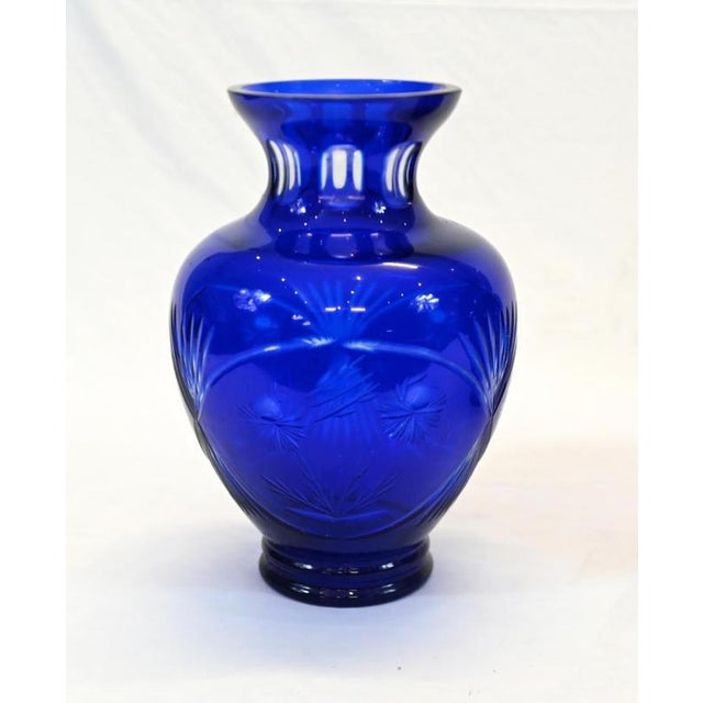 A striking pair of Art Deco style glass vases in rich cobalt blue The rounded bodies feature geometric cut decoration with...