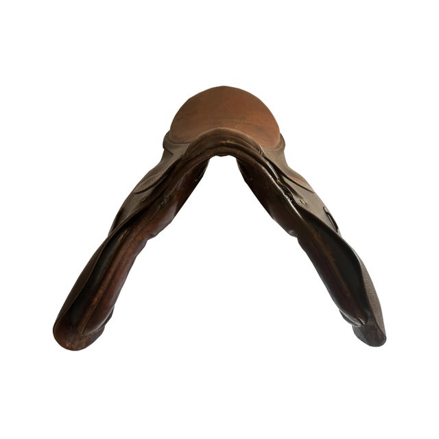 Here is a vintage English horse jumping saddle in a heavily distressed chocolate-colored leather, complete with the...
