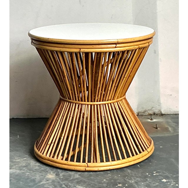 This charming vintage side table embodies the relaxed elegance of Mid-Century Coastal design, utilizing thin rattan sticks...