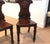 Beautifully carved mahogany hall chairs with armorial backs, hand-turned legs and solid mahogany seats. The chairs with...