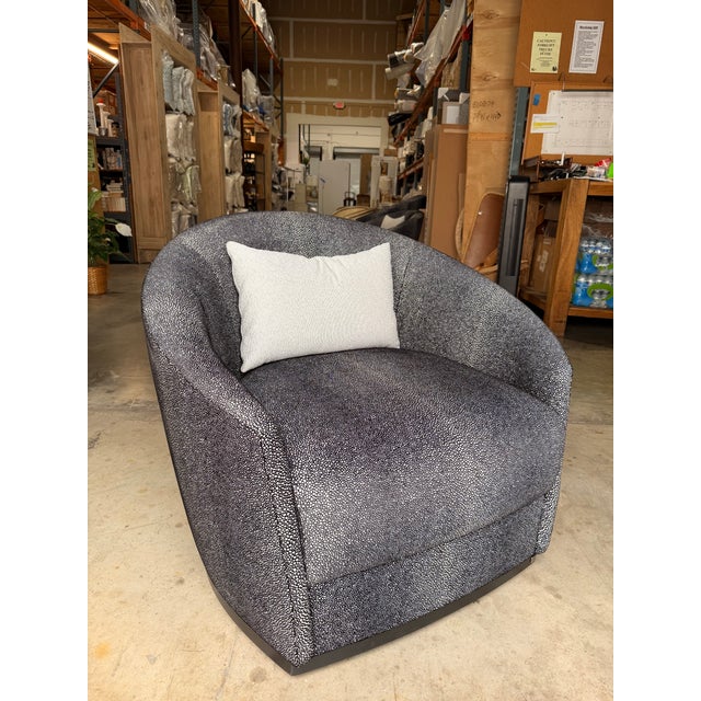 Bring a sophisticated statement to your space with this contemporary swivel chair, featuring plush Kravet charcoal, ivory,...