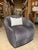 Bring a sophisticated statement to your space with this contemporary swivel chair, featuring plush Kravet charcoal, ivory,...