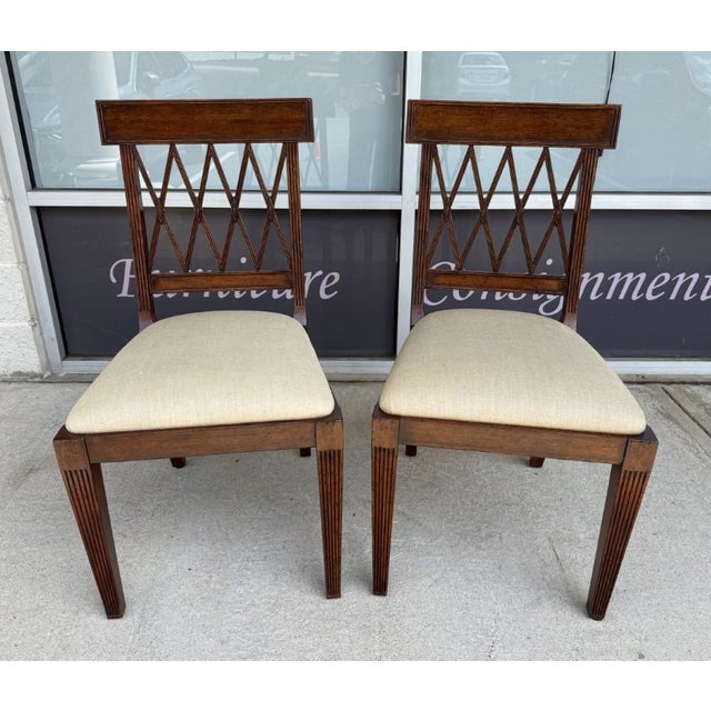 This pair of Jonathan Charles side chairs features elegant Regency-inspired styling with open lattice backs, reeded...