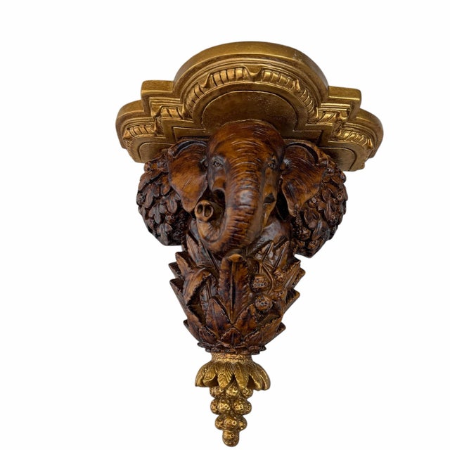 Offering this elephant decorative wall bracket / shelf in a tarnished gold and walnut finish. This decorative wall bracket...