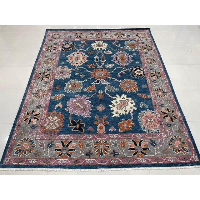 This blue wool rug features a hand knotted pile construction and reflects the distinct style of EORC Rugs. Crafted in...
