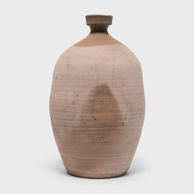 This large ceramic jar from China's Shandong province has a bottle-neck shape meant for storing vinegar or wine made from...