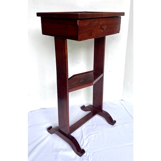 Vintage two-tier drink table with drawer. Gorgeous aged mahogany patina. A versatile petite accessory. The table measures...