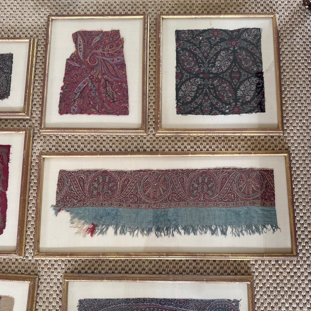 A striking collection of seven antique Kashmiri textile fragments, each individually mounted and presented in a...