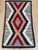 This striking mid-20th century Navajo rug is defined by a bold, rhythmic arrangement of interlocking chevrons and diamond...