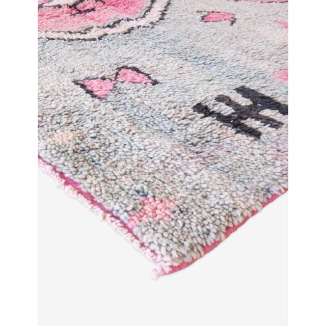 This Green Boujad Wool Rug adds a touch of boho chic to any space. Handknotted for durability, it measures 7.3 x 5 ft....