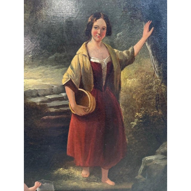 A charming 19th-century oil painting depicting two women in a verdant forest path—one standing barefoot with a straw hat,...