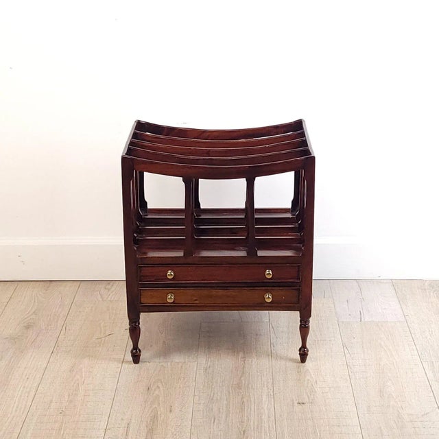 A Regency period mahogany Canterbury (magazine rack), England circa 1820. The Canterbury is on turned legs, with 2 small...