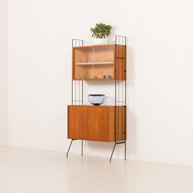 This italian mid-century free-standing wall unit with a display cabinet comes from the 1960s and is an elegant and...