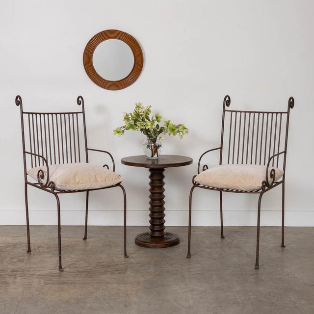 Lovely wrought iron chair from France, 1940s. Beautiful scroll iron design on arms with slated iron back and seat. Newly...