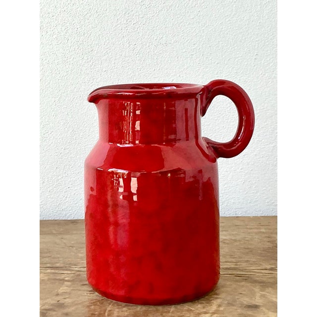 This vibrant 1960s Italian ceramic pitcher is a bold example of mid-century artisanal craftsmanship. Finished in a...
