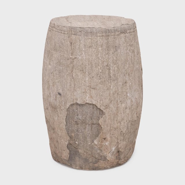 This low drum stool from Shanxi province was hand-carved from solid limestone nearly 250 years ago, designed to add the...