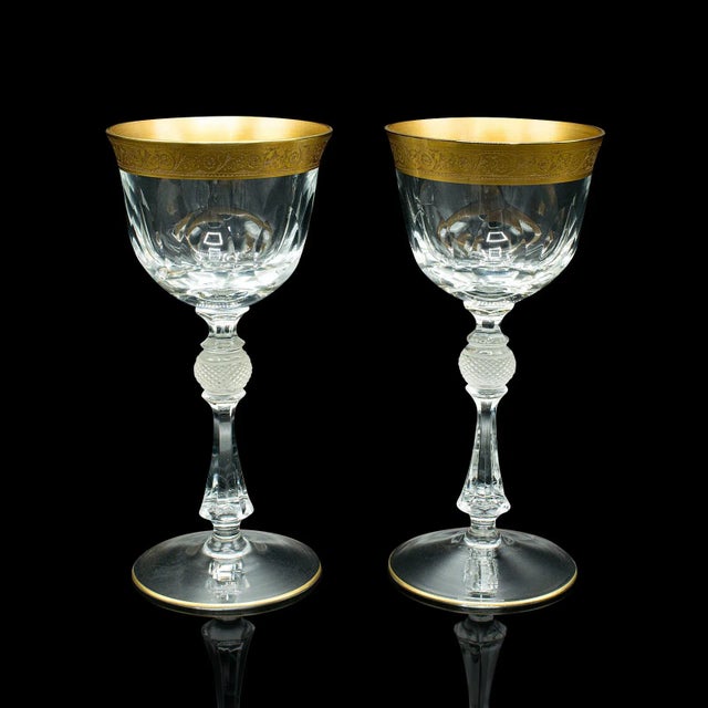 This is a pair of antique celebratory port glasses. A French, gilt decorated stem glass, dating to the Art Deco period,...