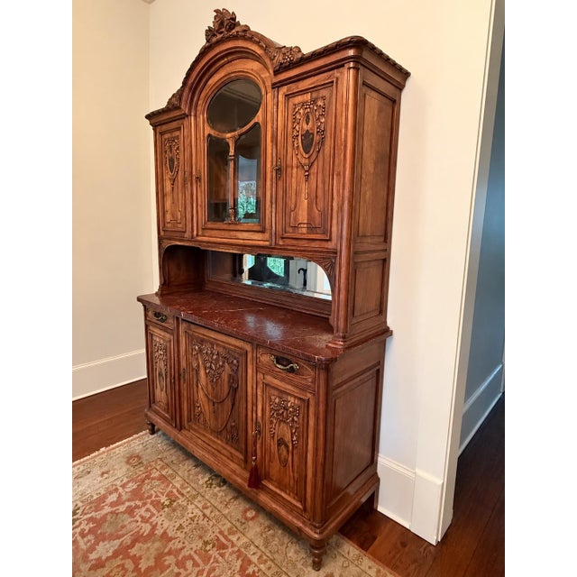 This is an exceptional antique French walnut buffet hutch, showcasing beautifully detailed carving, architectural...