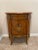 Italian neoclassical style accent cabinet. The lovely faux marquetry depicts a basket with flowers on the front of this...