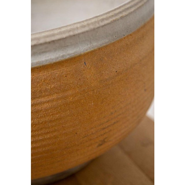 The mid century ribbed stoneware pot is hand-thrown with precision and care attributed to the skilled artisan bob kinzie....