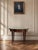 A beautifully decorative Italian parquetry inlaid tray table featuring a shaped top with geometric wood inlay, an inset...