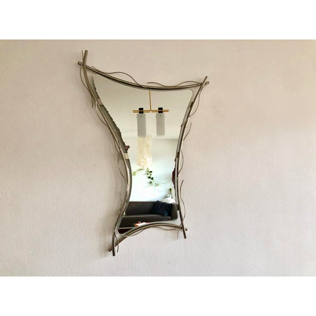 Large free-form mirror from the 1970s, made in Italy, some traces of use on the metal and the mirror (see photos).