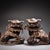 This is a matching pair of cast bronze guardian lion (Foo Dog) figurines, featuring a gilded finish with a dark, aged...