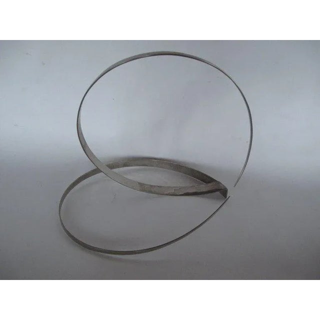 A stainless steel sculpture by Paul Sisco, ca' 1969. Made in the style of mid-century modern.