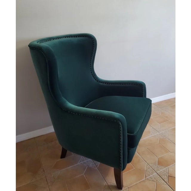 For sale is a beautiful high-back wing chair upholstered in a durable, easy-to-clean green velvet. A perfect accent piece...