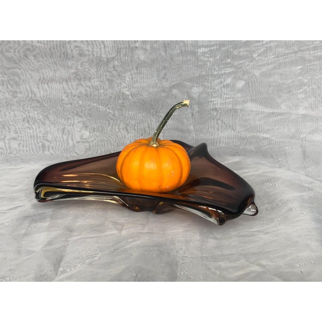 This classic mid-century modern Murano art glass bowl has a striking hand-blown free-form shape. The brown sculptural...