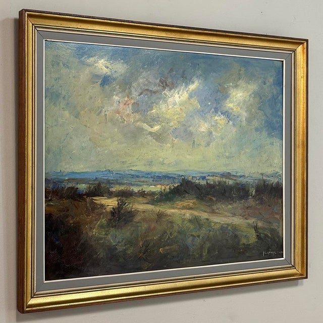 Expansive and atmospheric, this mid-century oil painting on canvas by Henri Lemoine captures a windswept countryside...