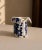 A whimsical and beautifully crafted signed studio pottery vase in the form of a tailored jacket, hand-decorated with bold...