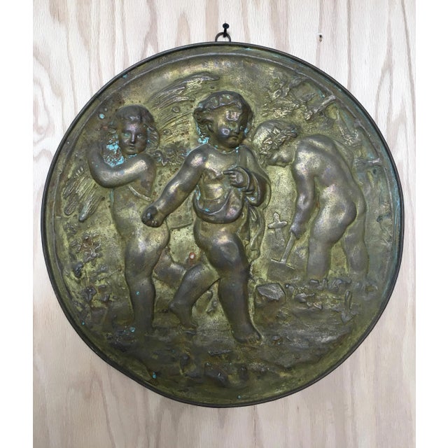 Pair of Antique 19th century angels at work brass repousse decorative rounds. One depicting harvesting the fields and the...