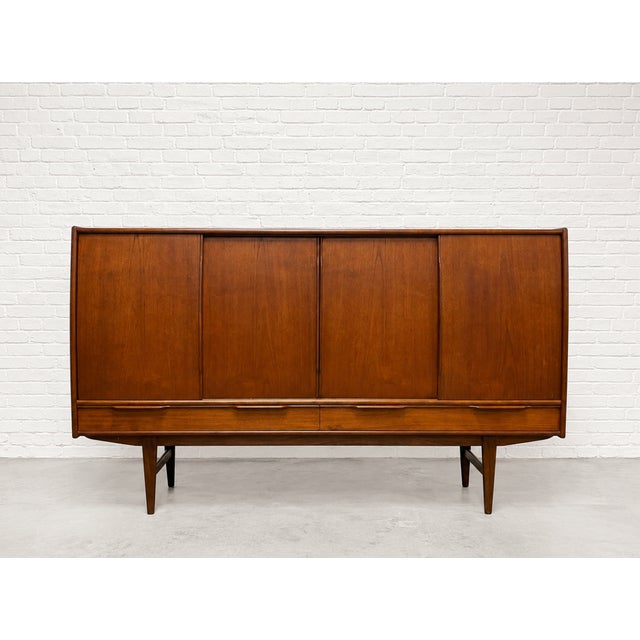 Large Mid Century Modern Danish Teak Highboard Credenza / Sideboard, by E.W. Bach, c. 1960's. This incredible piece is...