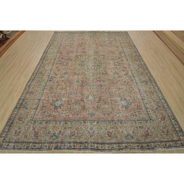 An authentic vintage traditional Tabriz rug hand-knotted with fine wool and natural dyes. This oriental rug features a...