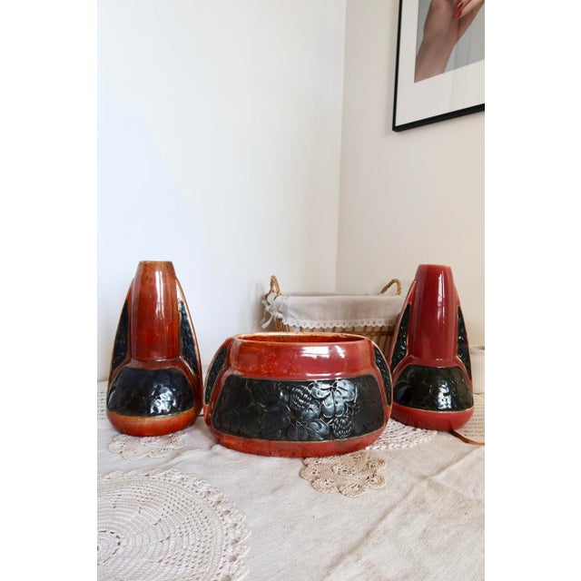 Enhance your interior with this unique set of vintage ceramics in deep red and black tones. Comprised of two slender vases...