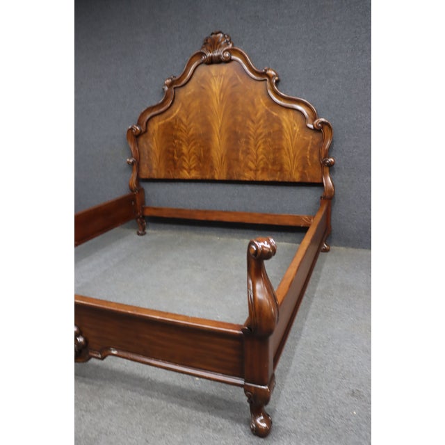 Elaborate carved bed attributed to the Thomasville Ernest Hemingway Collection, featuring a dramatic shaped headboard with...