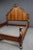 Elaborate carved bed attributed to the Thomasville Ernest Hemingway Collection, featuring a dramatic shaped headboard with...