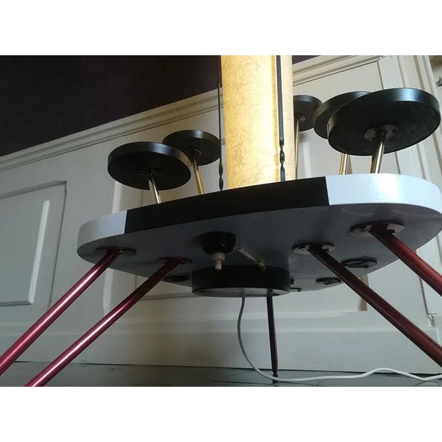 Surprising "tube" floor lamp on a 3-leg steel wire base. It is surrounded by 5 colored laminated satellites that can be...