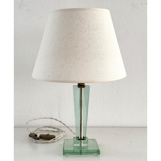 A beautiful green glass table lamp with brass details, originally from the 1950s. It is attributed to Fontana Arte, Italy....