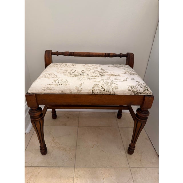 A charming circa 1930s walnut bench showcasing understated Classical Revival styling with beautifully turned details and...