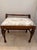 A charming circa 1930s walnut bench showcasing understated Classical Revival styling with beautifully turned details and...