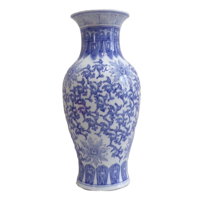 This vase showcases intricate hand-painted designs characteristic of traditional Chinese craftsmanship. Its elegant form...