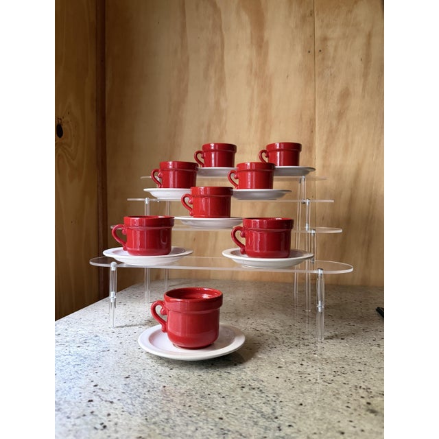 A striking and highly stylized set of 8 espresso or small coffee cups and saucers, handcrafted in the Netherlands by...