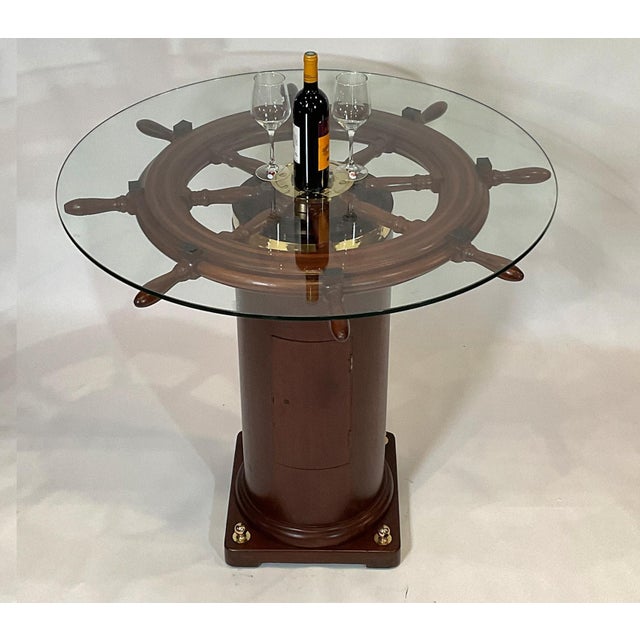 Quality eight spoke varnished ships wheel that is mounted to an authentic ships binnacle base. Both have been...