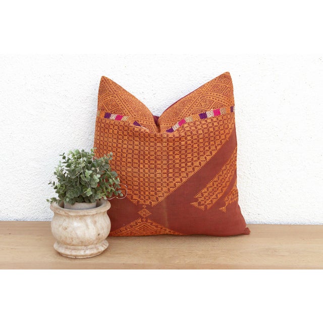 This 18-inch square pillow is a luminous example of Antique Phulkari craftsmanship, repurposed from a single, 19th-century...